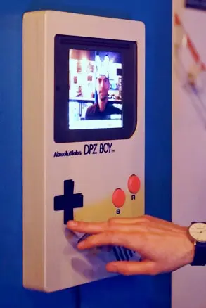 The white Photoboy in use, with a person operating the arcade controls.